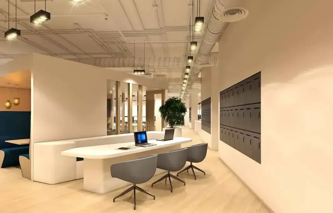 A bright and spacious modern office conference room with a large white table, sleek ergonomic chairs, and creative wall art.