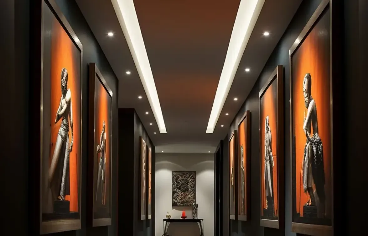 sleek and modern art gallery hallway with a minimalist design, track lighting, and a neutral color palette to highlight the artwork.
