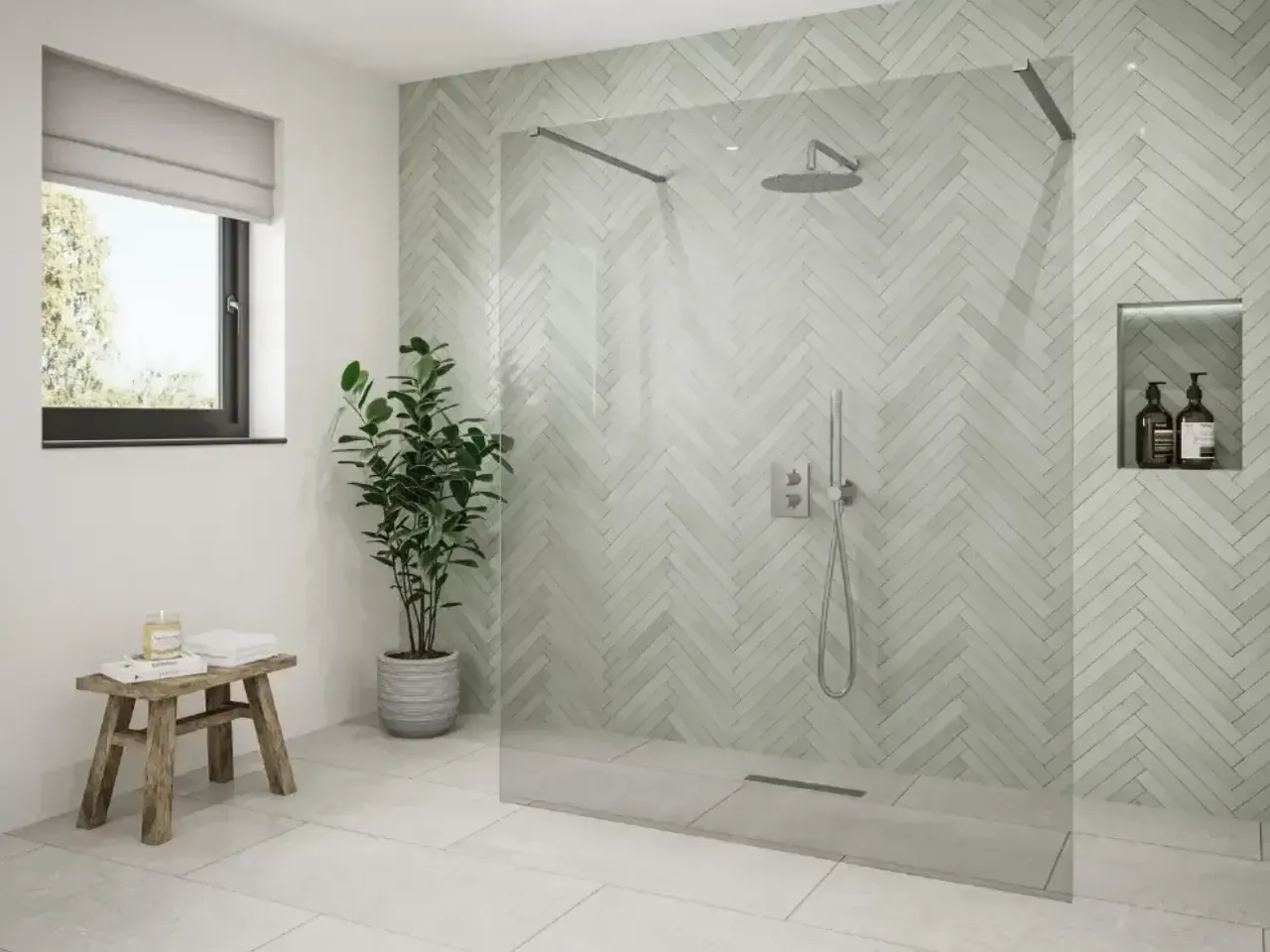 A modern bathroom with a frameless glass shower, green herringbone tile, and a potted plant for a touch of biophilic design.