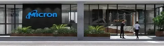 The exterior of a modern commercial building in Singapore, with large windows, minimalist architecture, and integrated planters.